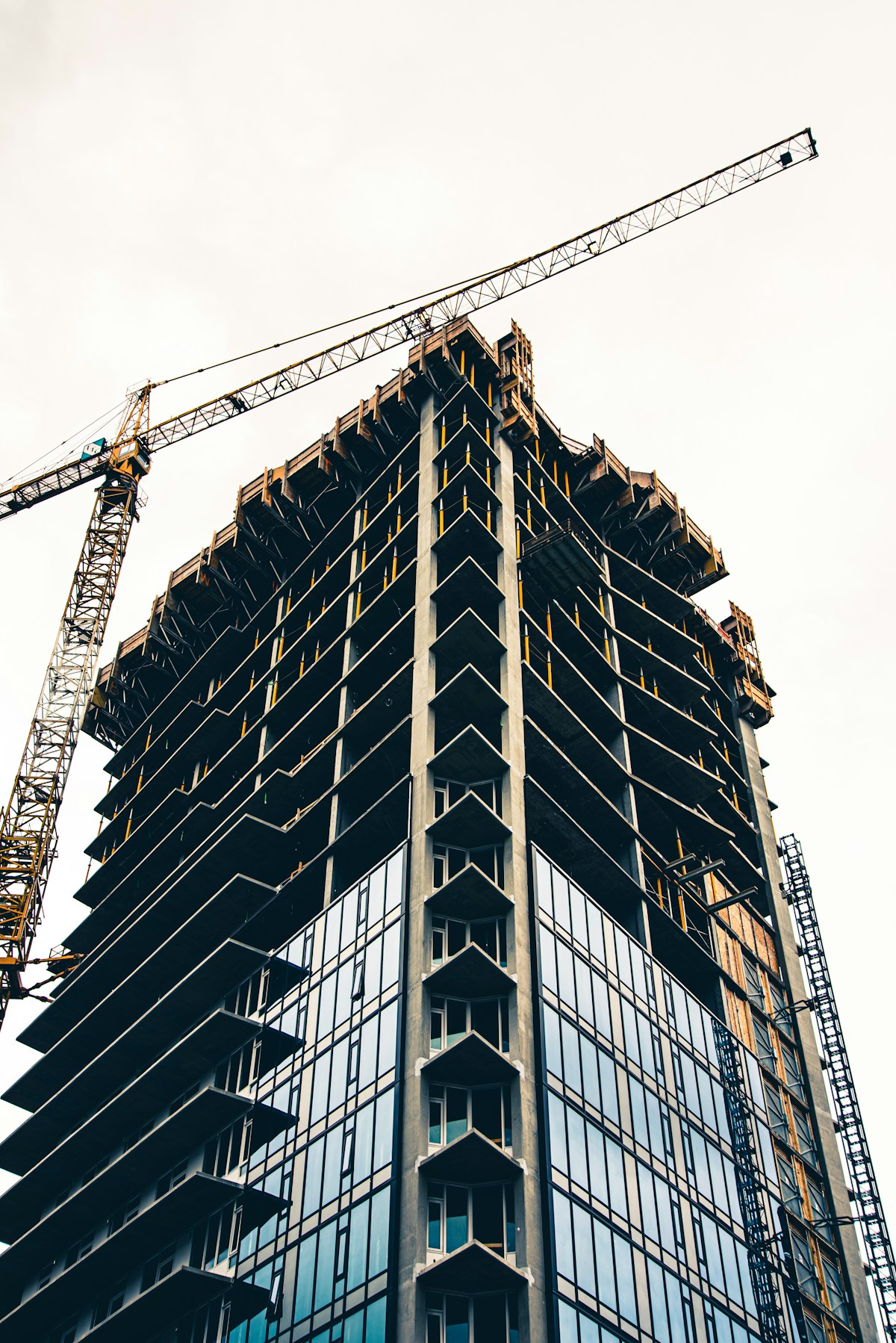 Yellow crane and building under construction